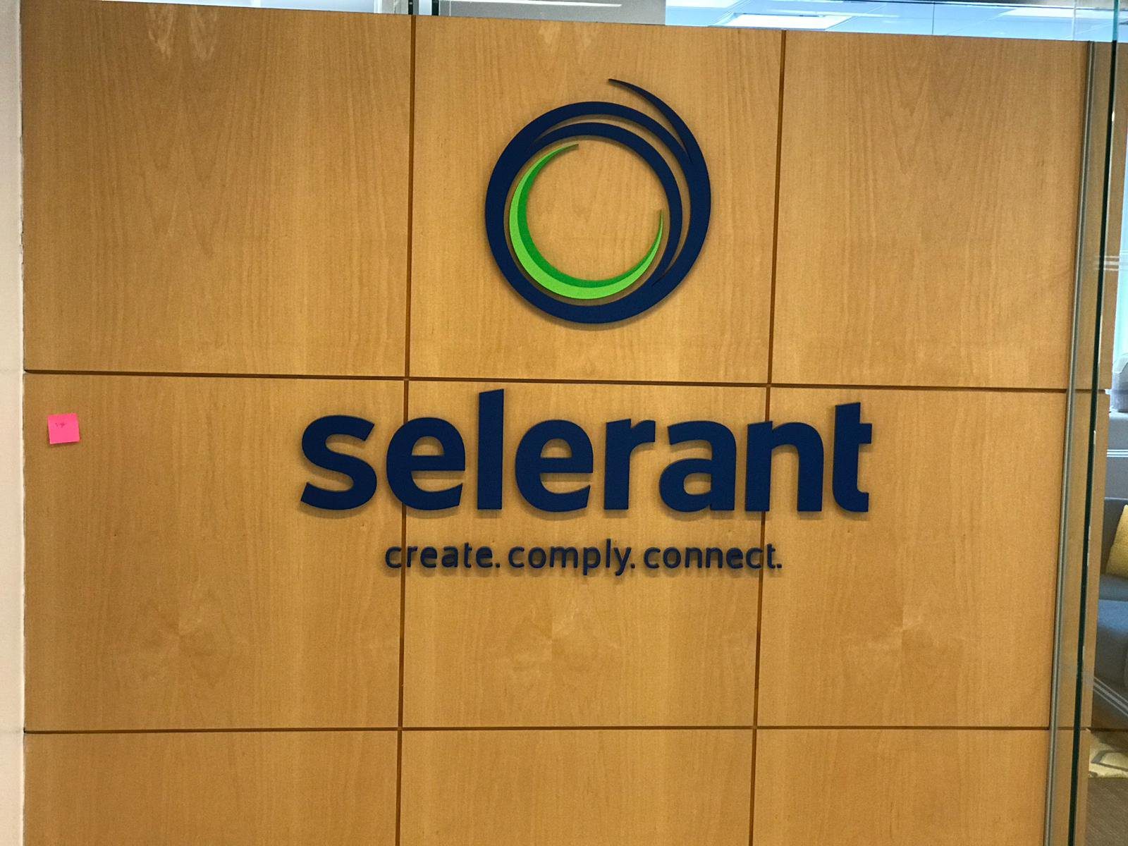 A sign that says selerant and reads " create. Comply. Connect ".