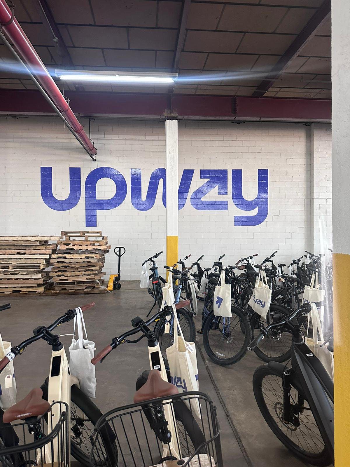 A warehouse filled with lots of bikes parked next to each other.