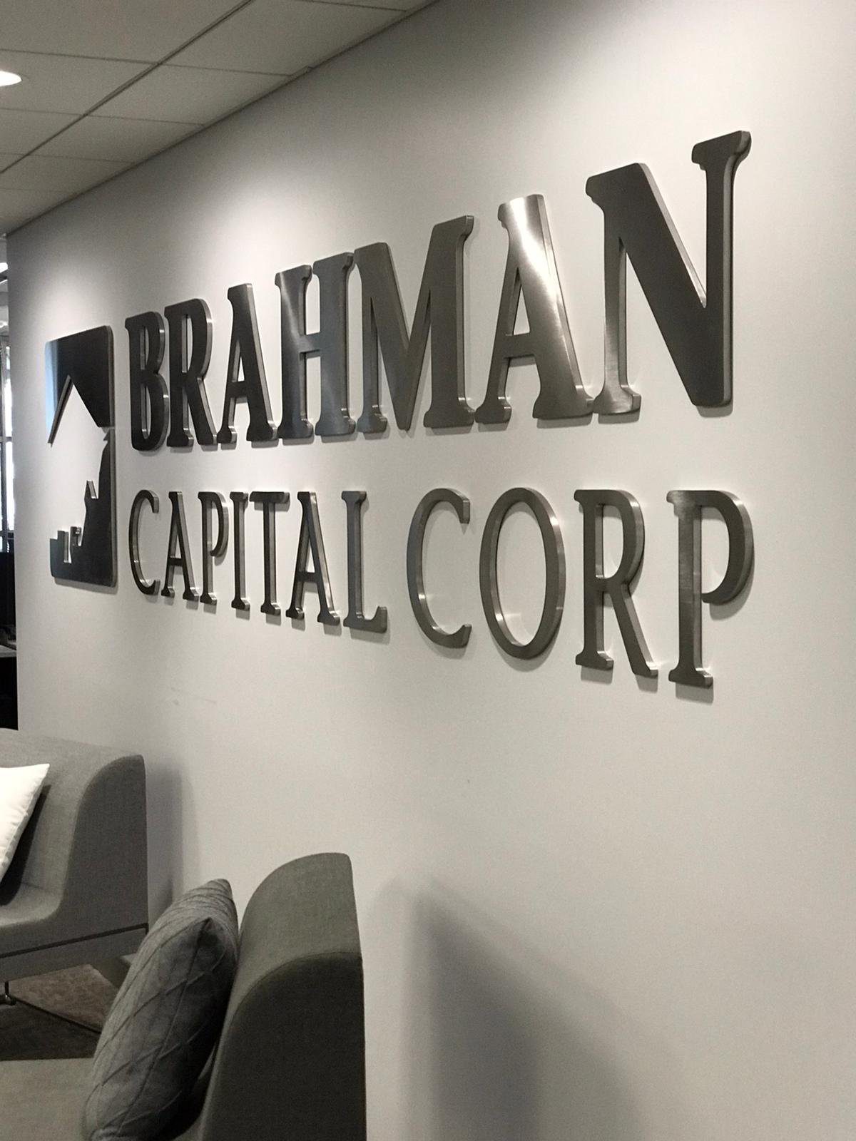 25a99459-7c1d-4eb8-96cb-d33aad672090 - MMK Custom Inc. Brahman Capital Corp logo on wall.