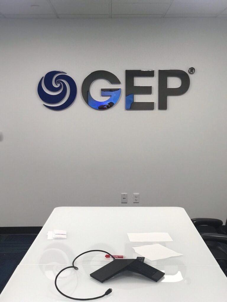 GEP logo on a white wall.